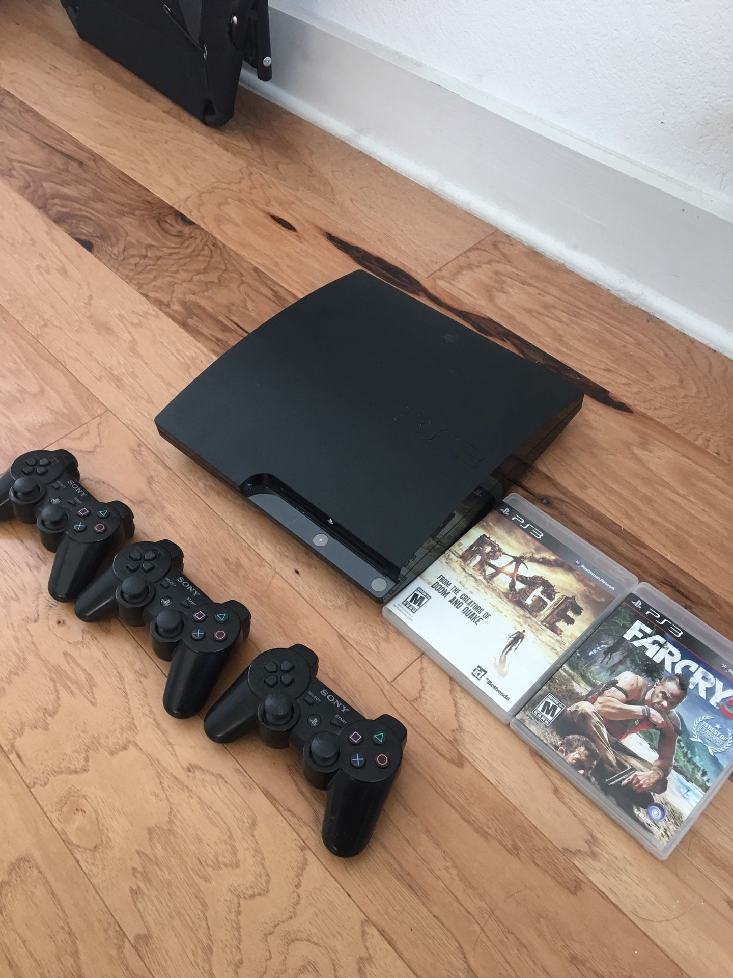 PS3 plus 3 controllers and 2 games