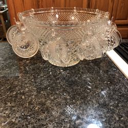 Vintage Glass Punch Bowl with 8 Cups.  Very pretty cut design.  No cracks or chips or brand.  No hooks included for the cups.  Preowned excellent cond