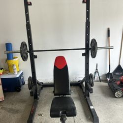 Squat Rack With Bar, Weights, And Bench. 