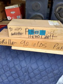 1990 98 olds Right hand headlight bezel & grille NOS.