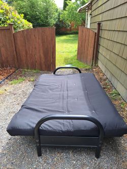 Black futon couch folds to full size bed