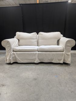 Light Beige Slipcovered Rolled Arm Couch