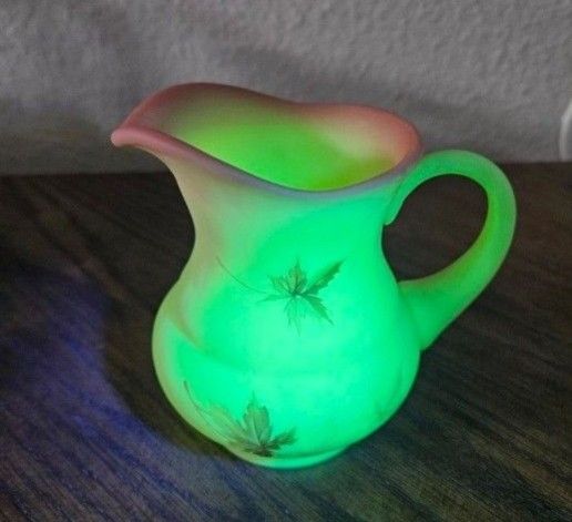 Fenton Autumn Leaf Hand Painted Burmese Custard Glass Vase Pitcher Measures 4 5/8“ at the widest point, 3 1/2“ deep, 4 1/2“ tall.