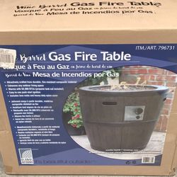 NEW IN THE BOX WINE BARREL GAS FIRE TABLE. IT PUTS OUT 50,000 BTU OF HEAT AND WORKS GREAT ON DECKS TO TAKE THE CHILL OFF.