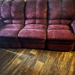 maroon three seat sofa both ends recliners