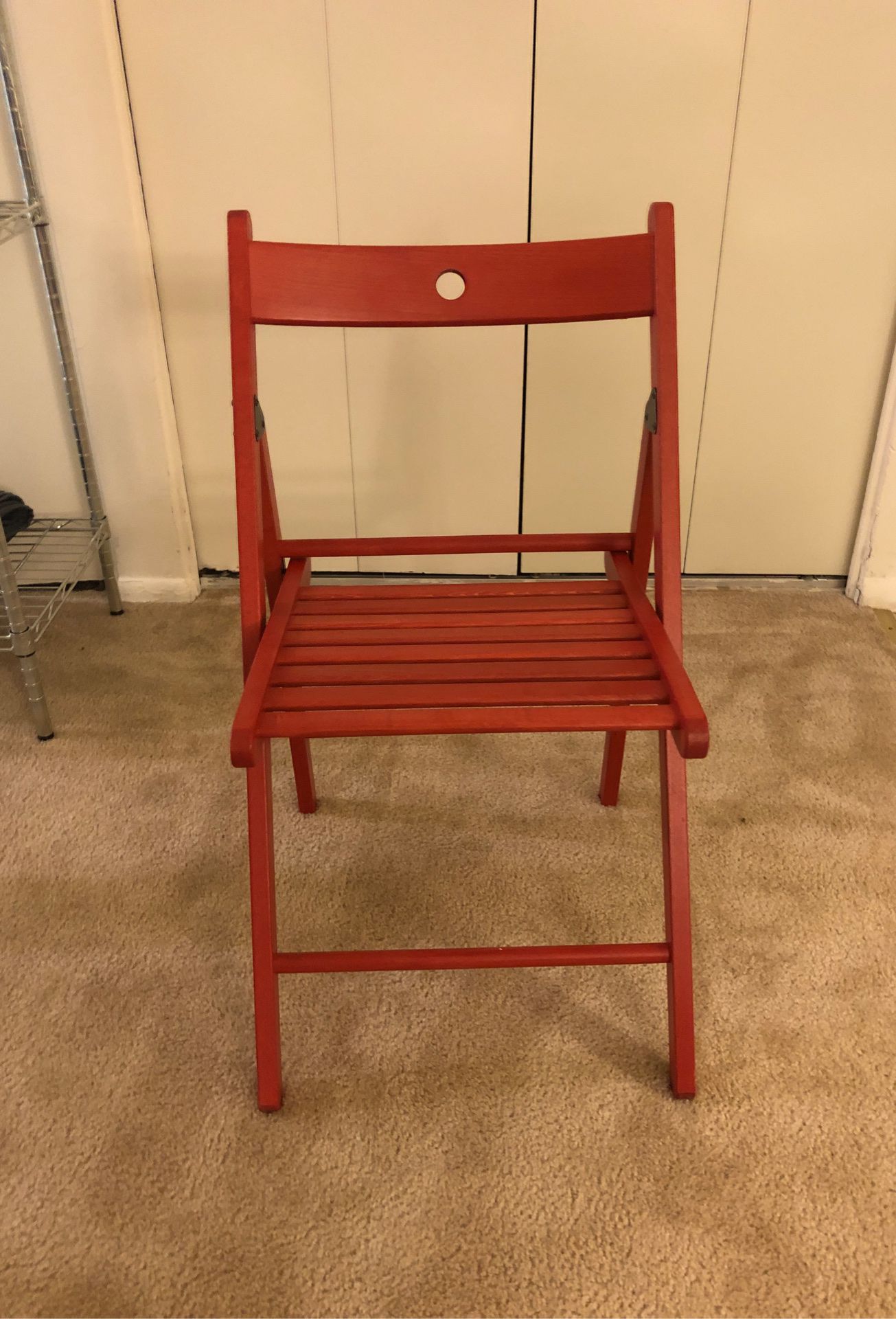 Red folded able sturdy wooden chair