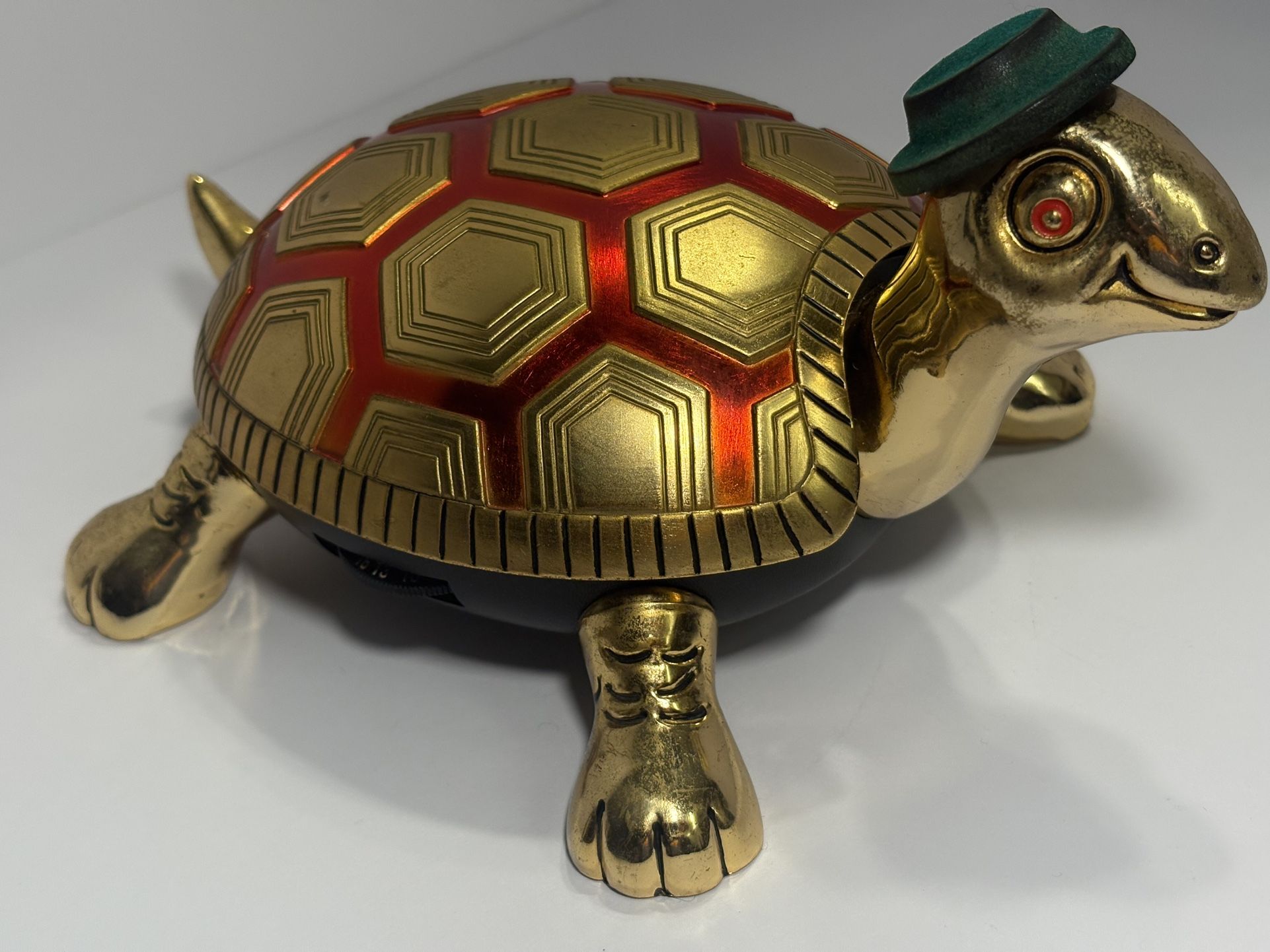 vintage Waco Model 611 novelty transistor radio shaped like a brass turtle, complete with a small green hat.