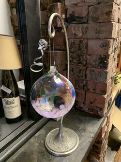 Hand blown glass ball with collectible stand.