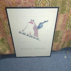 This is a Vintage framed art print featuring a cat playing the piano, by the artist Martha Wahlert. 
Signed By Artist