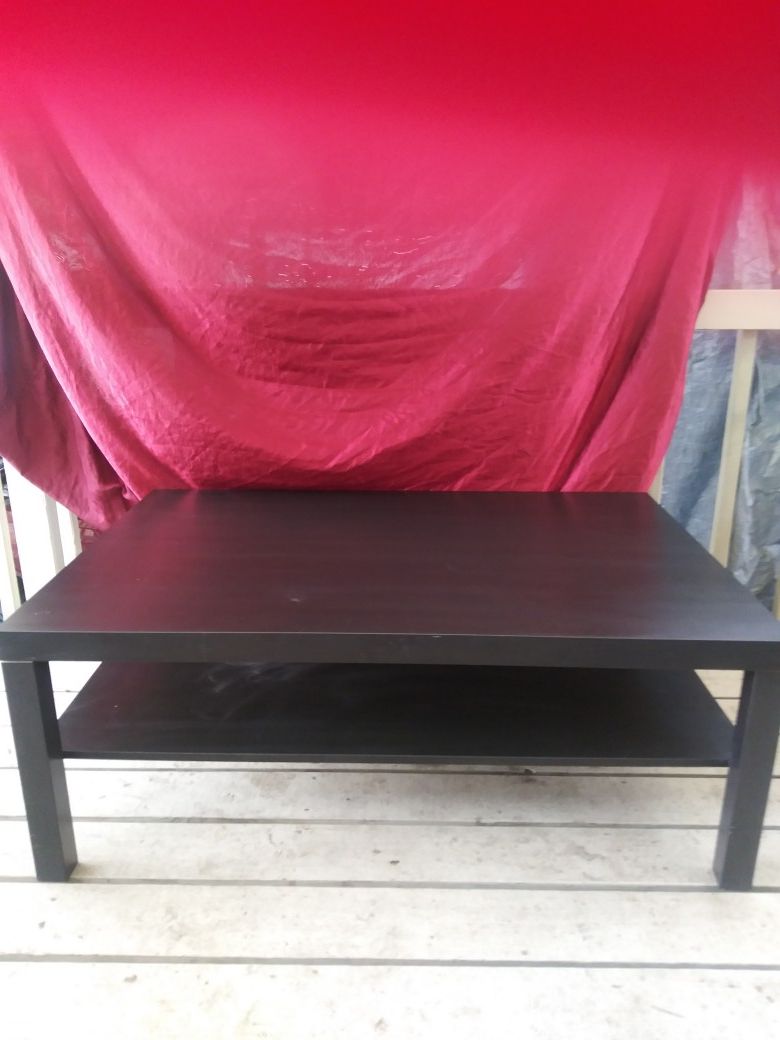 Black coffee table with shelf.