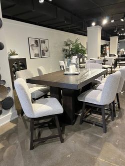 Modern dining set features double pedestal, thich table top & built-in wine rack