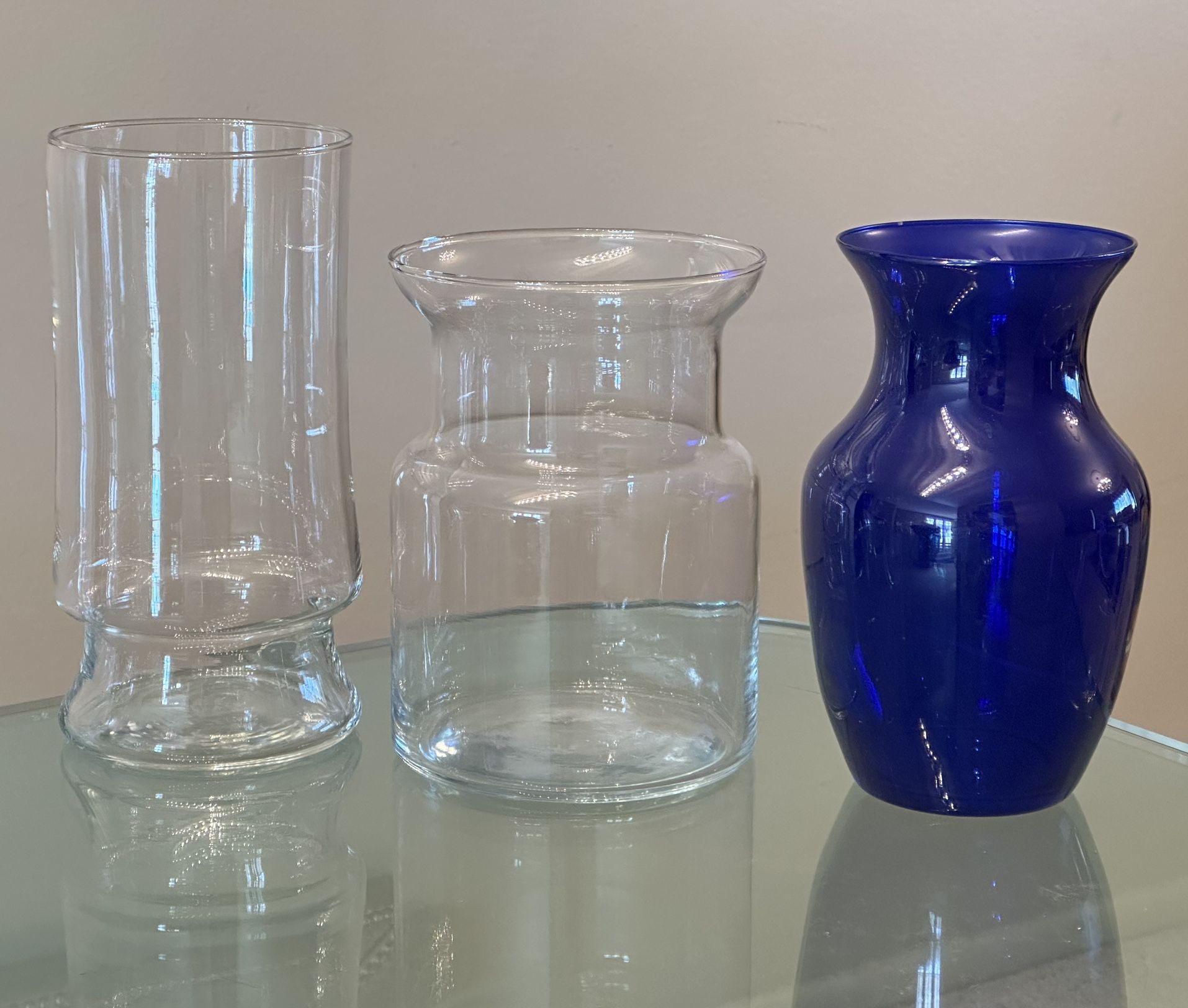3 Glass Flower Vases Two Clear Vases And One Blue Vase