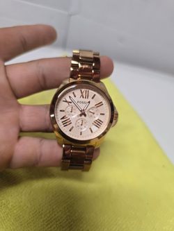 Fossil Cecile watch, specifically model AM4511, features a polished rose gold-tone stainless steel band and case