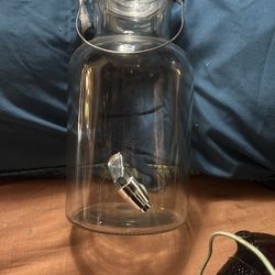 Glass tea jars with nozzle.