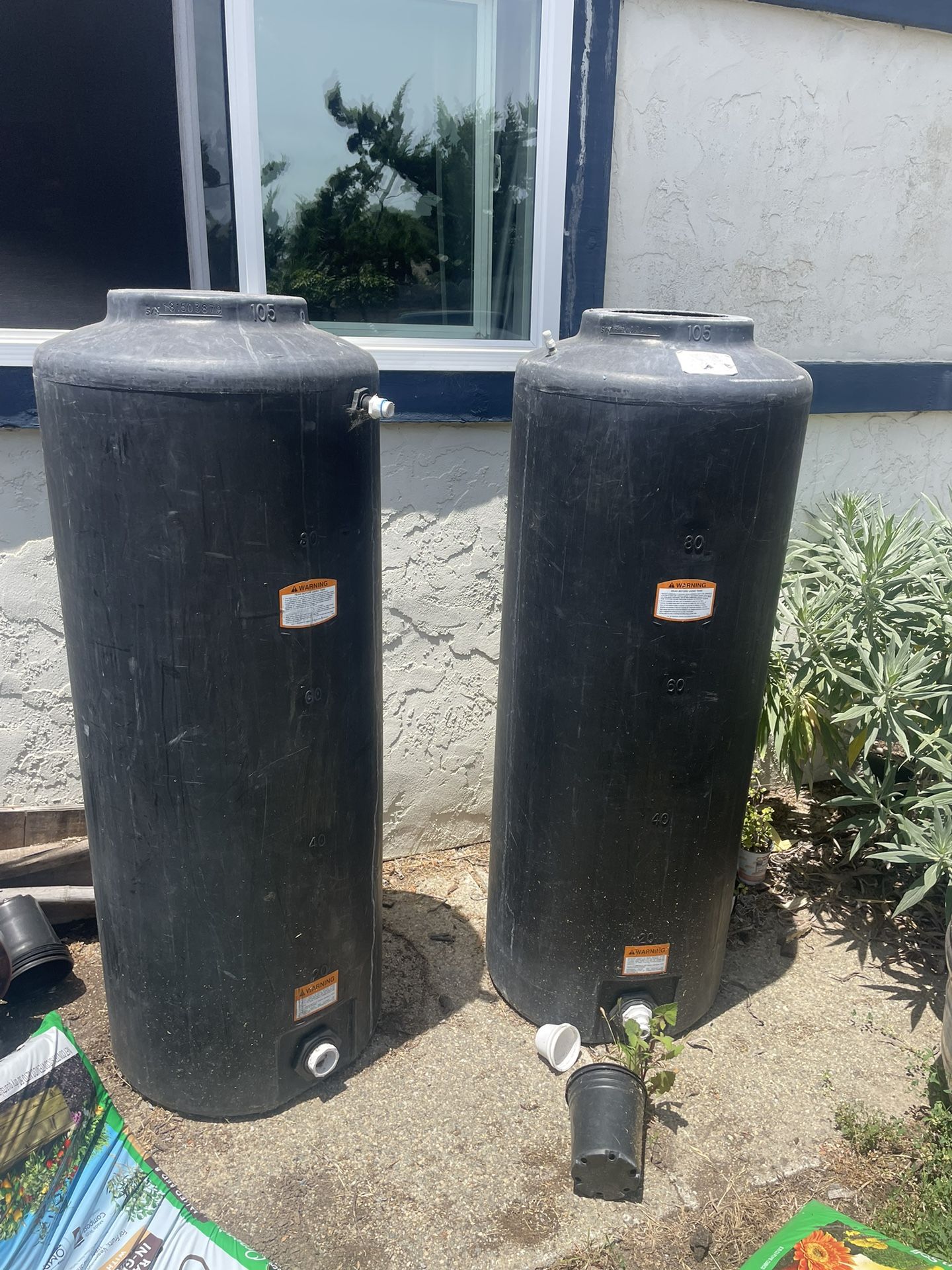 Two 105 Gallon Water Storage Tanks
