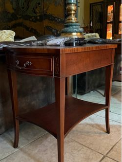 PAIR OF MAHOGANY END TABLES W/SERPENTINE TOP AT FRONT AND VALUE BACK, HAVE ONE DRAWER, UNDERSHELF AND SLIGHTLY TAPERED LEGS. BY IMPERIAL OF GRAND RAPI