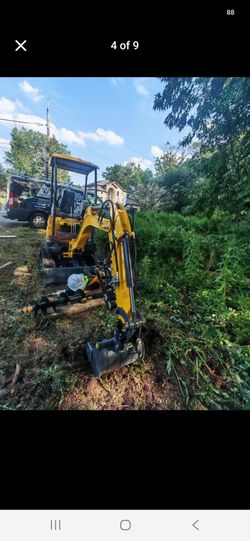 Yellow Mini Excavator with Auger Attachment