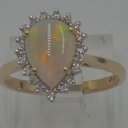 14kt yellow gold ring size 6  2.7 grams 19 round diamonds 0.25 carat with opal . mint condition. 