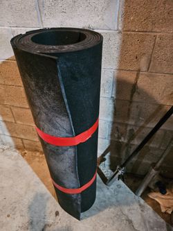 Heavy-duty black rubber mat roll measures 4x10 feet. This mat is made of thick rubber material.