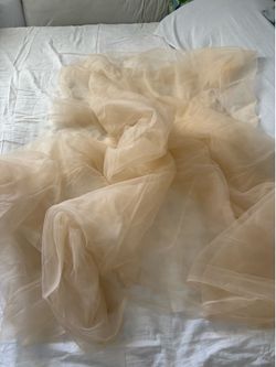 Soft sheer fabric has a light beige color. Material is lightweight and flowy. Great for dresses , crafting or decorating. Approximate 82” length, 50” 