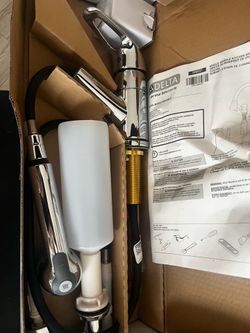 Brand New Delta Kitchen Faucet – Chrome Includes pull-down sprayer, soap dispenser, and all installation hardware. Brand new in the original box.