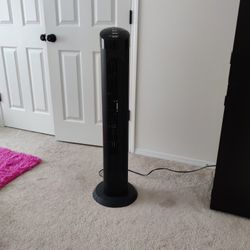 Black  tower fan with oscillating capabilities for broad room coverage.