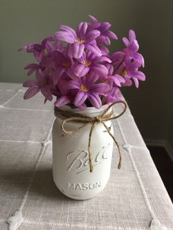 Distressed mason jar with silk flowers