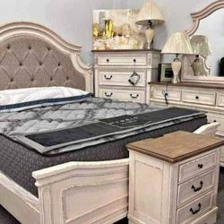 Realyn Queen Upholstered Panel Bed With Mirrored Dresser, Chest and Nightstand
