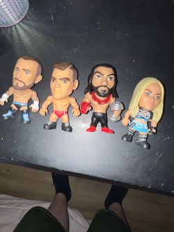 4 mini wwe figures (cm punk, Roman reigns, Gunther & liv morgan)