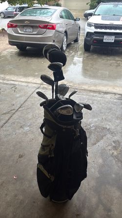 Golf bag with golf clubs and sticks