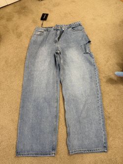 PrettyLittleThing Light Blue Wash Baggy Low Rise Asymmetric Waistband Jeans