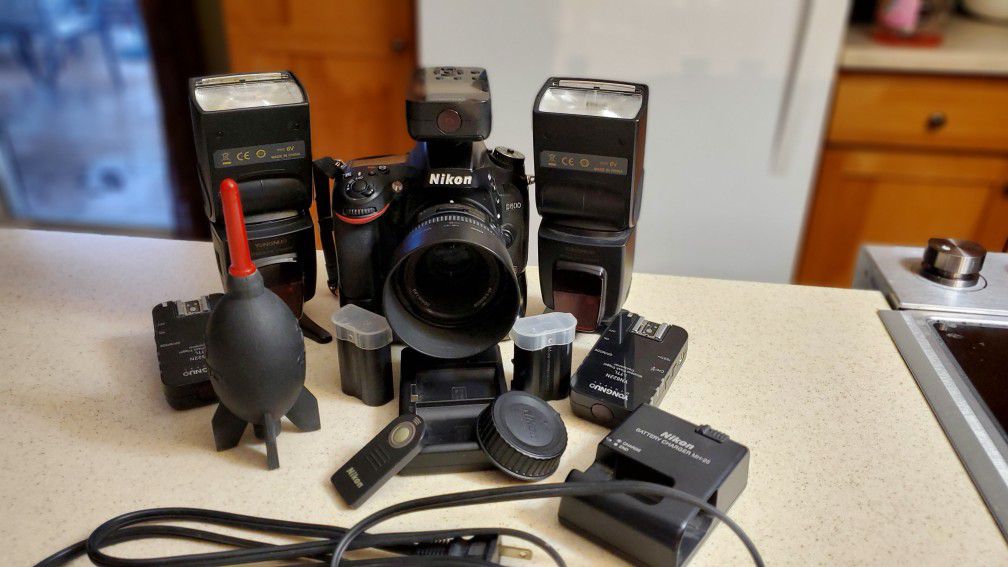 Nikon D600 with 50mm f/1.8 lens, 35mm Lens, flashes, transmitters