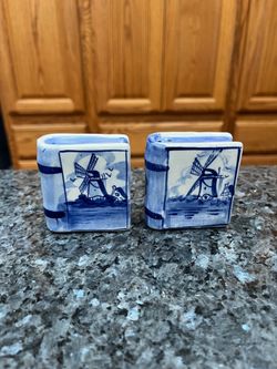 Vintage Ceramic Books With windmills Blue and White Design Pair of Salt and Pepper Shakers.  Size approximately 2 1/2 inches tall.  Preowned never use
