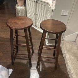 Two wooden bar stools in good condition
