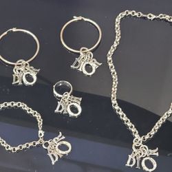 Vintage silver tone ring, earrings,  chain with pendant & bracelets floating spell out with embellished White Rhinestones on Letter O

A chic silver  