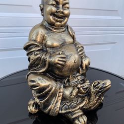 The Laughing Buddha On A Turtle Statue
