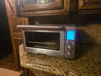 This is a Breville Smart Oven Pro featuring a brushed stainless steel finish and a digital LCD display.This countertop oven utilizes Element IQ techno