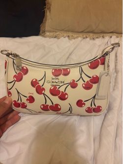 Cherry’s coach purse
