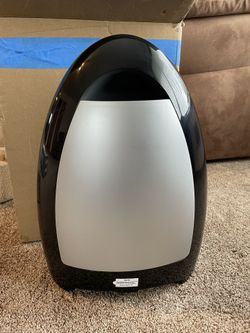 stationary vacuum cleaner that automatically activates when debris is swept near its inlet.