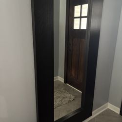 two living room tables and a large mirror