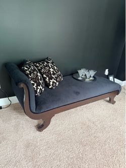 Newly/used upholstered black velvet chaise lounge chair with two decorative pillow in gold and black