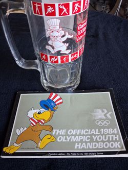 1984 Olympic mug, with the official 1984 youth Handbook.