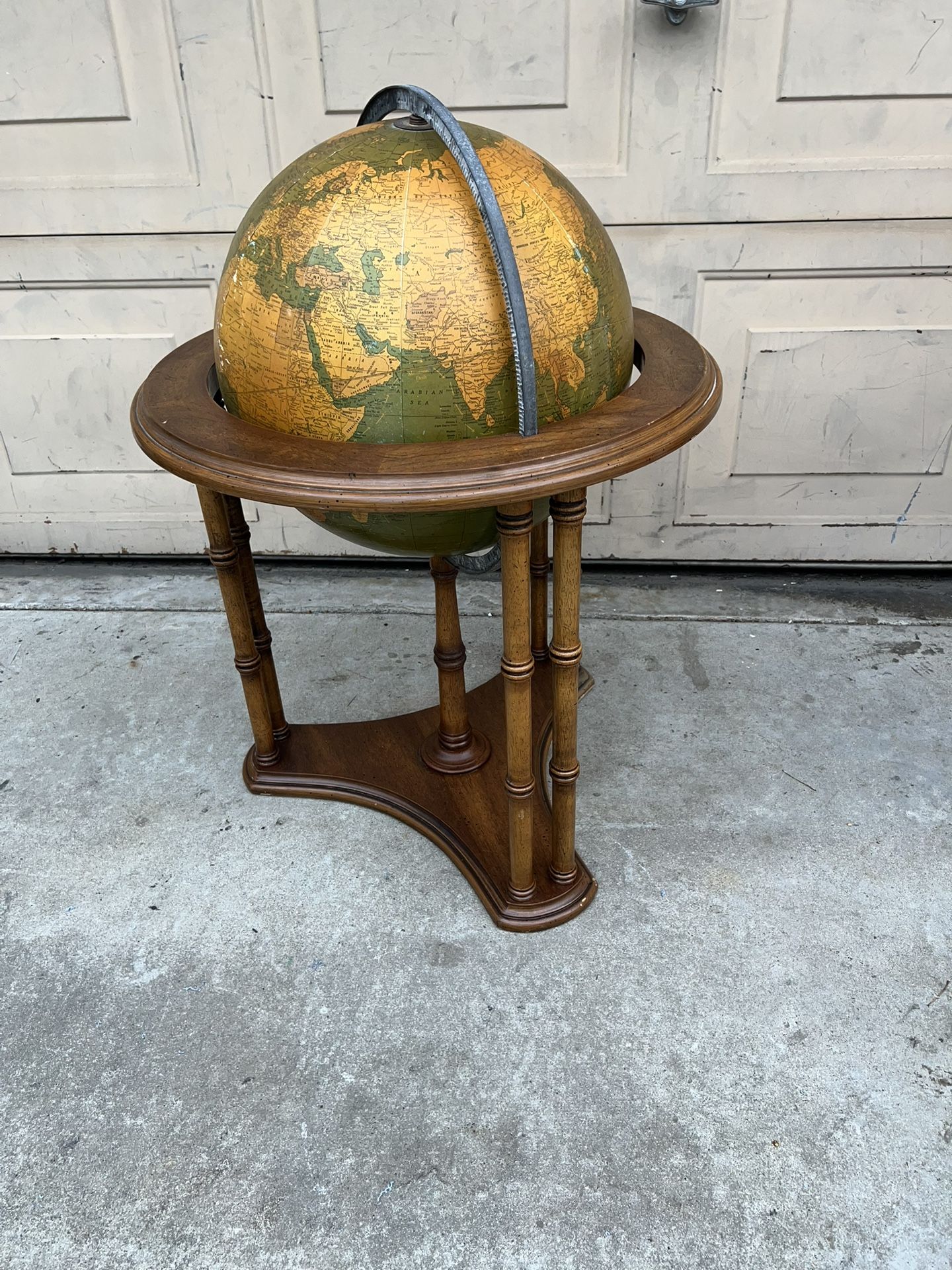 VINTAGE WORLD GLOBE WITH MUTED COLOR AND WOODEN STAND