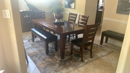 Dining table and chairs with additional benches seat four or eight