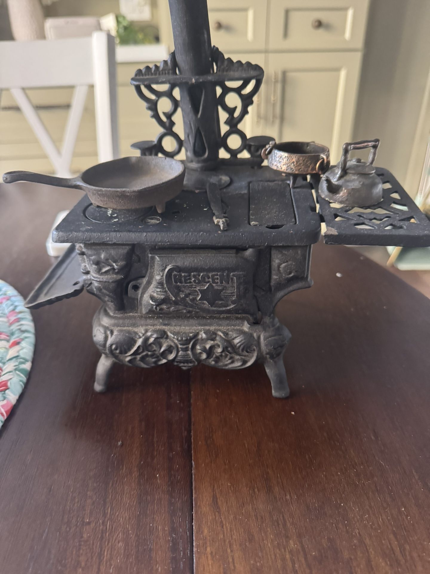 Miniature Crescent cast iron stove And Several Porcelain Dolls