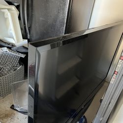 65 inch floor model TV with a back 100