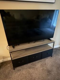 Brown and black TV stand