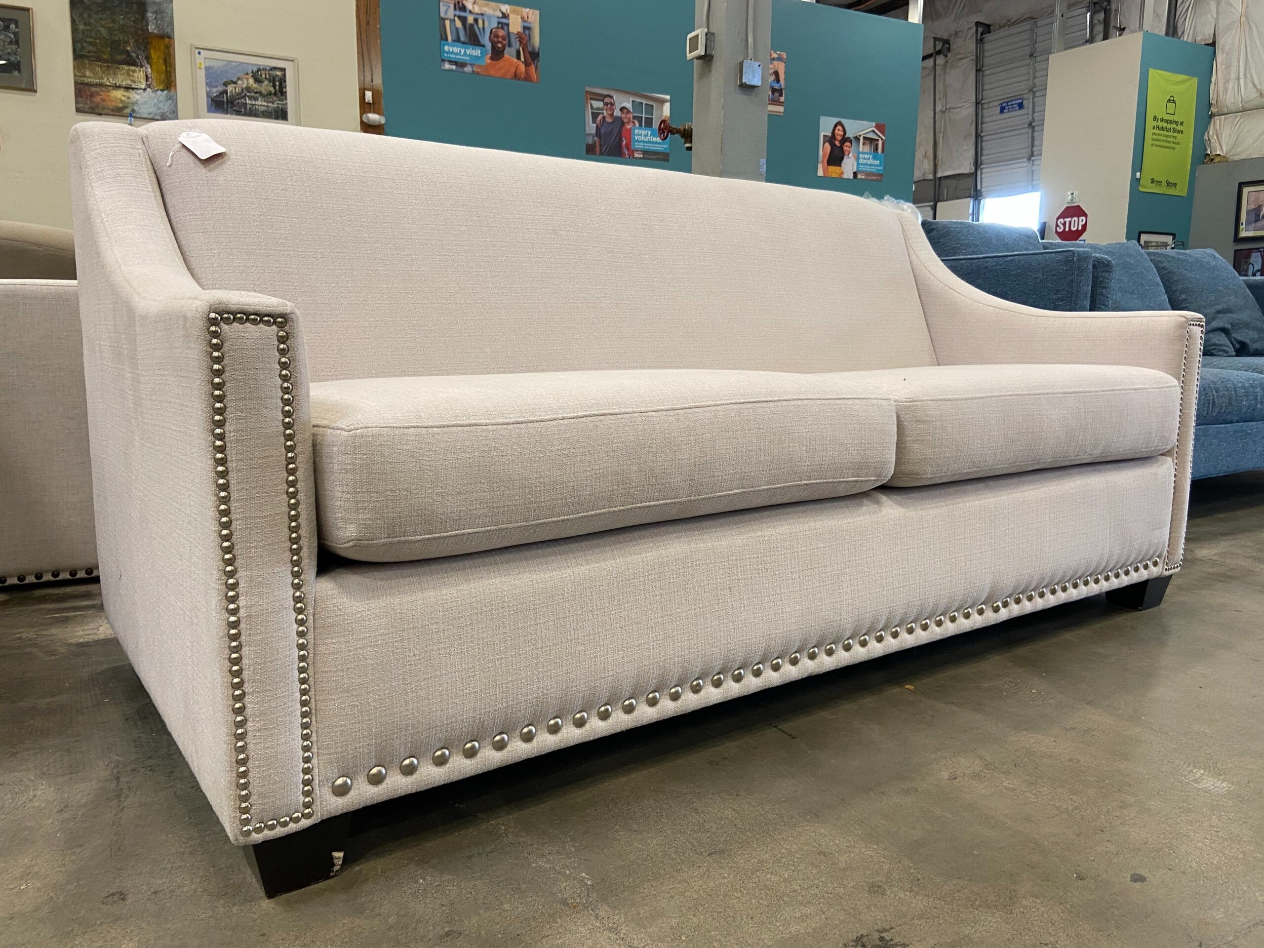 Cream Sofa with Sloped Arms and Nailhead Trim
