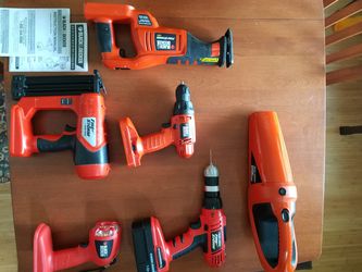 black & decker drill with dual chuck, vacuum, light, reciprocating saw, and another drill, 18 volt set, includes charger and one battery.