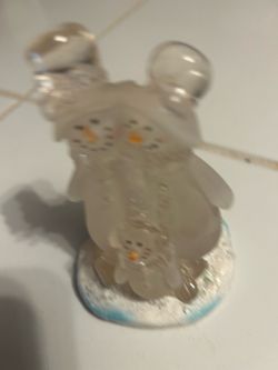 frosted acrylic or glass snowman family figurine standing on a snowy base.
